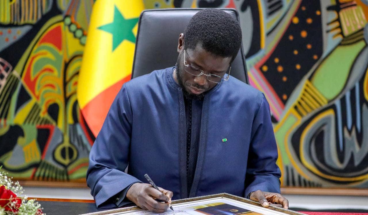 President Bassirou Diomaye Faye signing documents