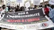Protesters in Dakar hold signs reading "no to homosexuality" during a demonstration demanding stricter anti-LGBTQ+ laws