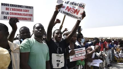 Protesters holding signs during a demonstration in Dakar on February 20, 2022, demanding stricter penalties for homosexuality.