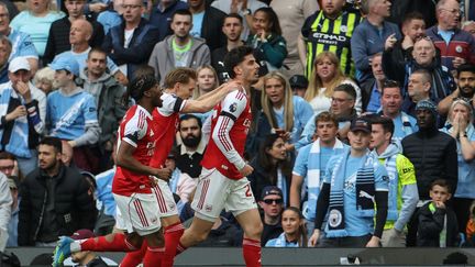 Arsenal players celebrating a goal against Manchester City