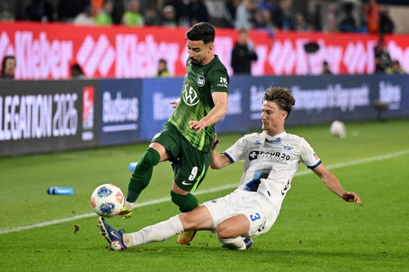 Wolfsburg players in action against Paderborn during the Bundesliga playoff first leg