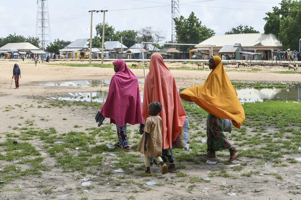 Survivors and relatives of victims of a suspected Boko Haram attack walk in Babban Gide on September 4, 2024. At least 81 people died and several are missing after an attack by presumed Boko Haram jihadists in Yobe State, northeastern Nigeria.