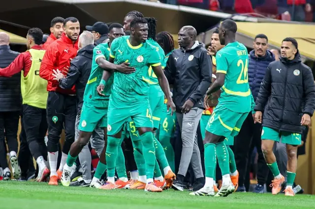 Senegal players protesting against the referee