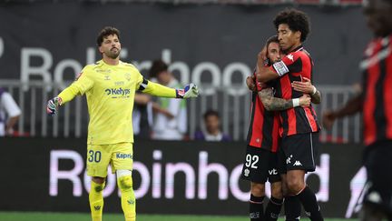 Jonathan Clauss and Dante celebrate after Clauss opens the scoring for Nice in the Ligue 1/Ligue 2 playoff return leg against Saint-Étienne on May 29.
