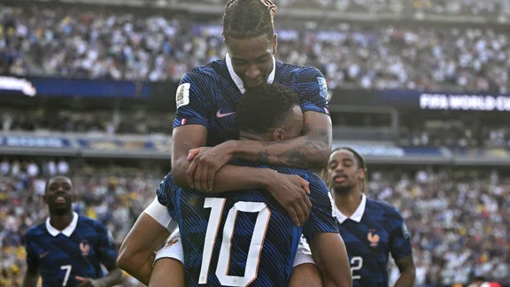 Michael Olise and Kylian Mbappé celebrating during a World Cup match