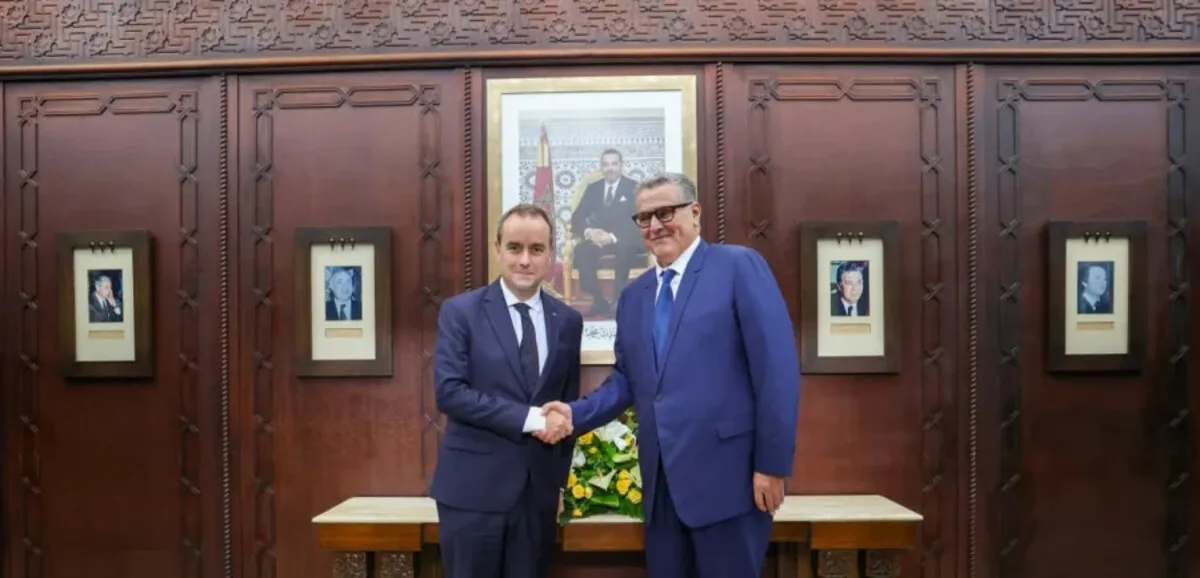 French and Moroccan leaders shake hands during a strategic partnership meeting