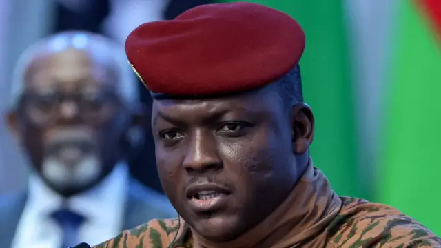 Close-up of Ibrahim Traoré wearing a beige military uniform and red beret
