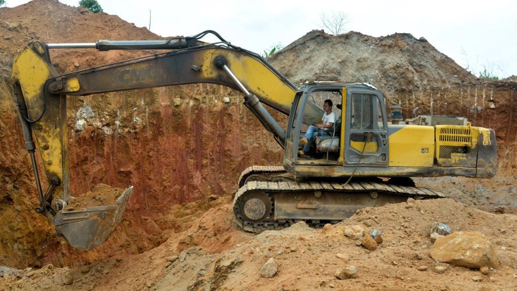 A Chinese employee of a mining company operates a bulldozer at a gold mining site in Betare Oya, Cameroon, April 4, 2018.