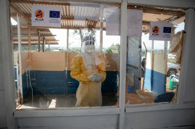Healthcare workers in protective gear treating Ebola patients