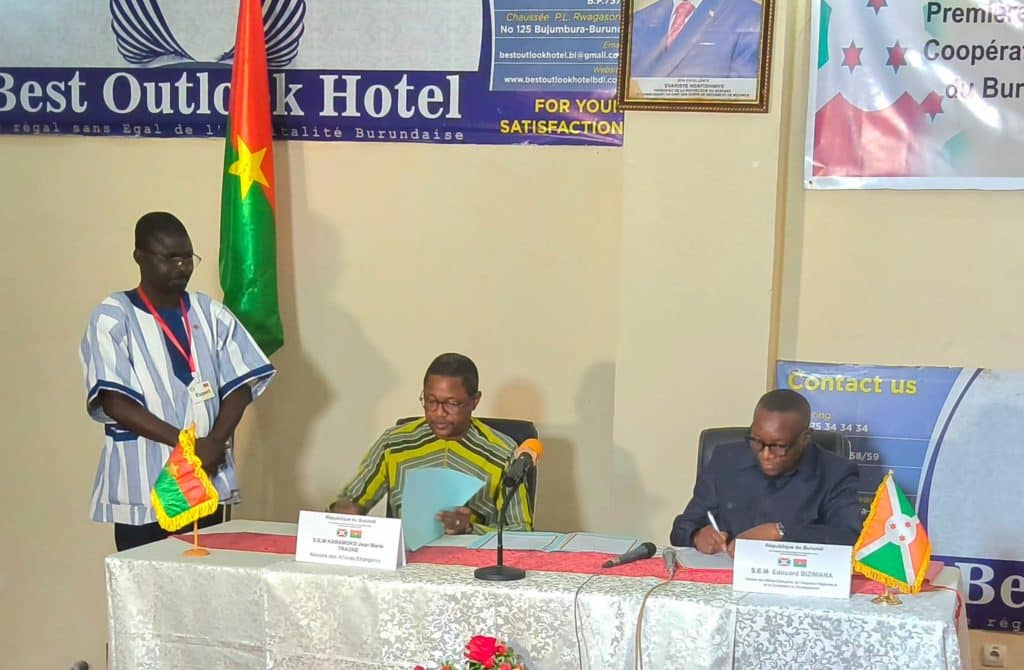 Burkina Faso and Burundi officials shake hands during a signing ceremony
