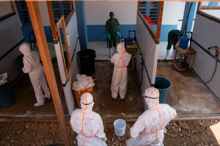 Health workers in protective gear attending to Ebola patients in a Congolese hospital